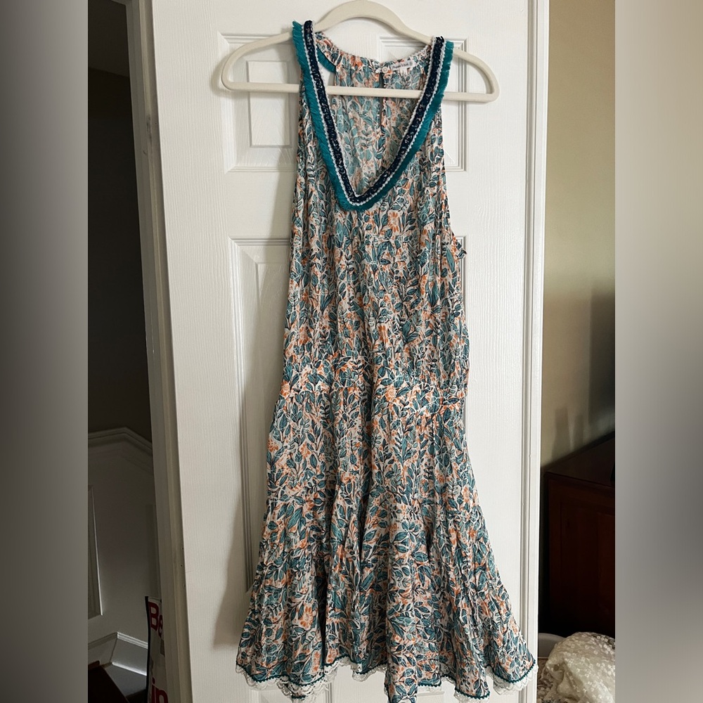 Beautiful cover up! Has elastic waist and key hold in the back! Lightly worn